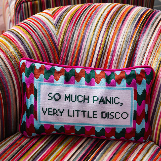 Decorative pillow with text on a multicolored striped chair