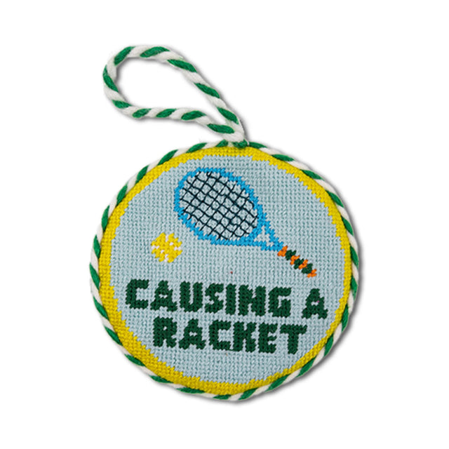 Round dog toy with tennis racket design and text 'Causing a Racket' on a white background