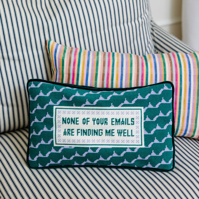 Decorative pillow with text on a striped sofa