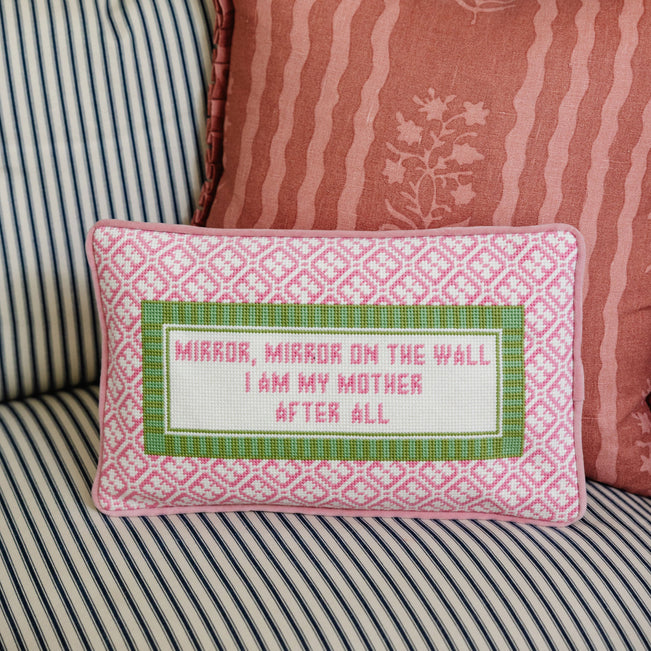 Decorative pillow with text on a striped sofa