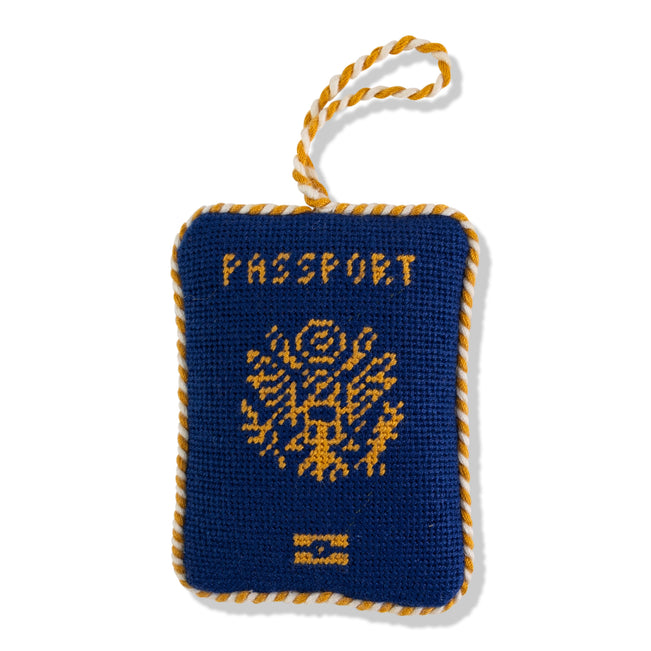 Blue and yellow passport-shaped toy with a rope handle on a white background