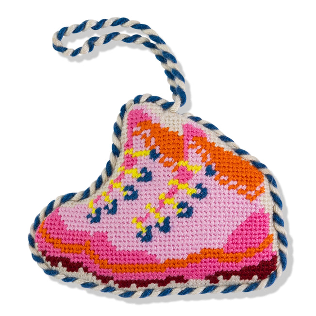 Heart-shaped knitted toy with colorful patterns on a white background