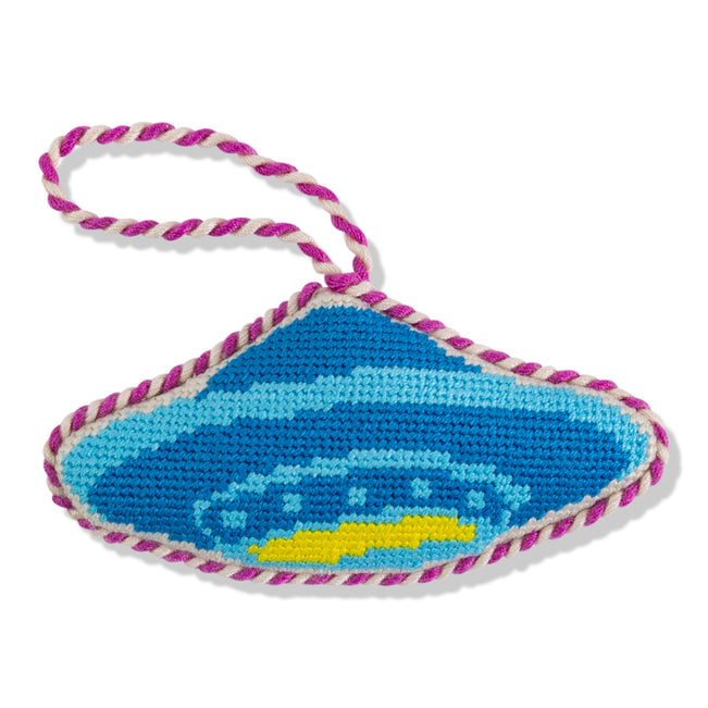 Blue and yellow car design on a knitted eye patch with pink and white trim.
