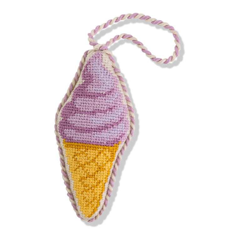 Knitted ice cream cone keychain with pink and yellow colors on a white background