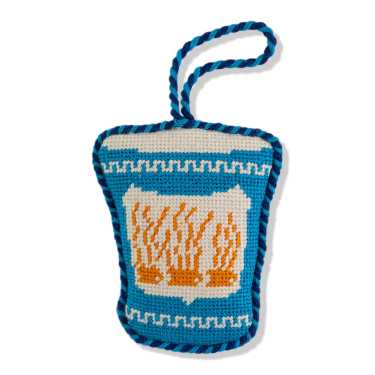 Crocheted bag with a design of flames on a white background