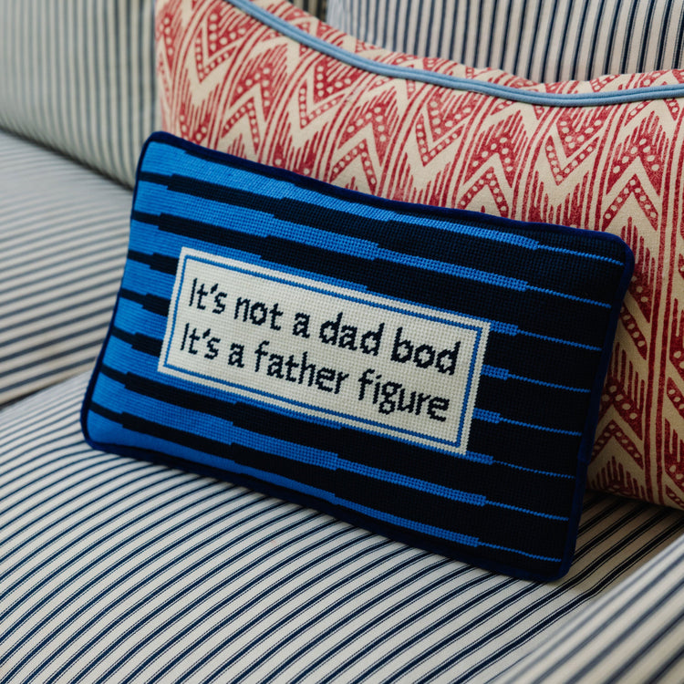 Decorative pillow with text on a striped fabric background